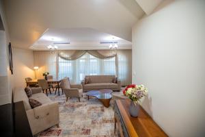 a living room with a couch and a table at Niamey Mall & Residence in Niamey