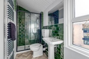 a bathroom with a toilet and a sink at Sandy House in Scarborough +11 photos