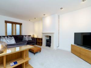 a living room with a couch and a television at Pass the Keys Modern 3 bed home with offstreet parking in Bath