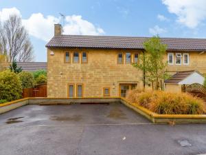 an empty parking lot in front of a brick house at Pass the Keys Modern 3 bed home with offstreet parking in Bath