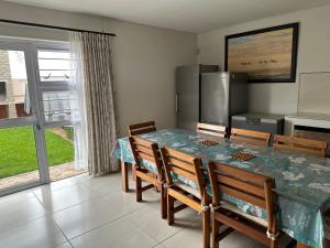 a dining room with a table and chairs at Sandy Shores 3 Henties in Hentiesbaai