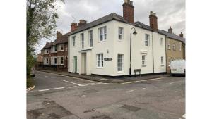 a row of white houses on a street at Beautiful Apartment Central Oxford in Oxford