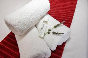 a white towel with a bottle of moisturizing moisturizers on it at OnQ Accommodation in Bellville