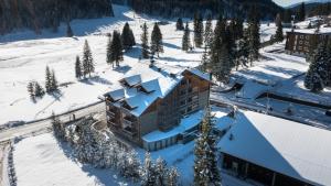 an aerial view of a building in the snow at Maribel Hotel in Madonna di Campiglio