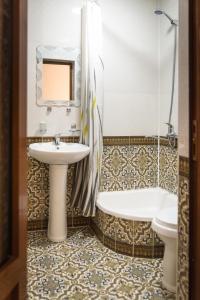 a bathroom with a sink and a tub and a toilet at Hotel Ravshan Boutique in Bukhara
