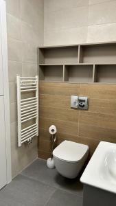 a bathroom with a toilet and a sink at The Comfy Nest in Cluj-Napoca