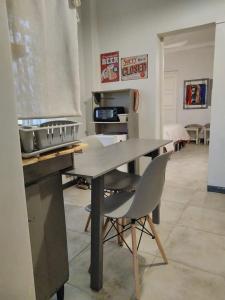 a kitchen with a table and a stove and a chair at Loft Rufino in Mendoza
