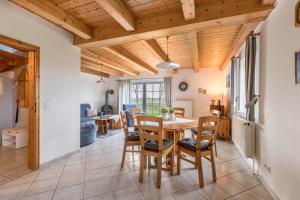 a kitchen and dining room with a table and chairs at Schäferhof Dircks Fewo 3 in Westerhever