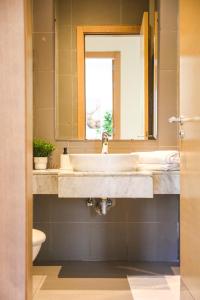 W łazience znajduje się umywalka, lustro i toaleta. w obiekcie YourPlace - Luxury - Prestigia Hay Riad w mieście Rabat