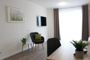 een woonkamer met 2 stoelen en een tafel bij greenpartment Boardinghousehotel Kelheim in Kelheim