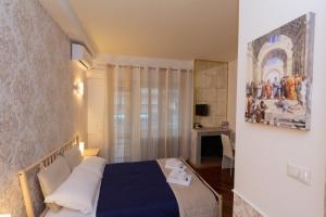 Un dormitorio con una cama y un cuadro en la pared. en Aurelio Deluxe Rooms, en Roma