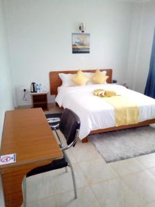 Un pat sau paturi într-o cameră la Sai Inn Eldoret