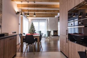 a kitchen and dining room with a table and a christmas tree at Holiday Home Kamienok 2 in Liptovský Mikuláš