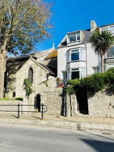 a white house on the side of a street at Kearney Cottage - Artist's Retreat in Portland