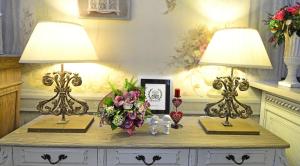 
a white table topped with a vase filled with flowers at Hotel De Paris in Moscow
