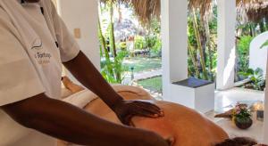 a man is working on a pillow in a room at Hotel La Tortuga in Las Terrenas