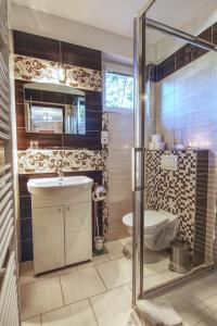 a bathroom with a shower and a sink and a toilet at Apartmány PACIFIC in Demanovska Dolina