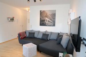 a living room with a couch and a tv at Ferienwohnung Frischluft in Garmisch-Partenkirchen