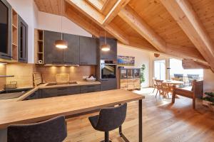 a kitchen with a wooden table and chairs at Chalet Wild in Garmisch-Partenkirchen +11 photos