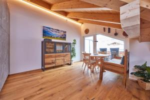 a living room with a table and a dining room at Chalet Wild in Garmisch-Partenkirchen