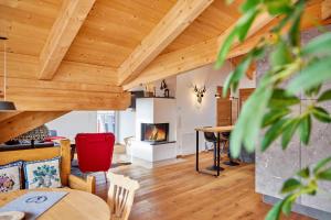 a living room with wooden ceilings and a fireplace at Chalet Wild in Garmisch-Partenkirchen