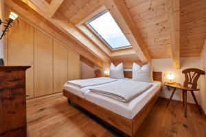 a bedroom with a large bed with a skylight at Chalet Wild in Garmisch-Partenkirchen