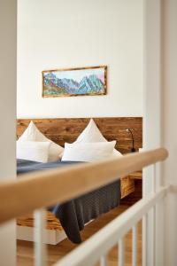 a bedroom with a bed with pillows on it at Hirsch in Garmisch-Partenkirchen