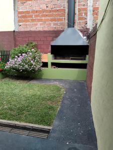 a bench in front of a brick building with flowers at Casa Magali in Federación