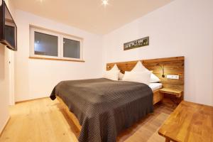a bedroom with a large bed and a television at Hirsch in Garmisch-Partenkirchen