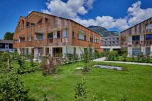 a building with a green yard in front of it at Hirsch in Garmisch-Partenkirchen
