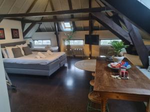 a living room with a bed and a table at Hotel Oldenburg in Zwolle