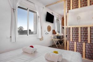 um quarto com duas toalhas numa cama com uma janela em Casa Chipiron em Vejer de la Frontera