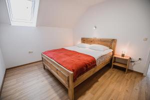 a bedroom with a bed and a table with a lamp at Mojčin Pisker Apartment House in Kranj