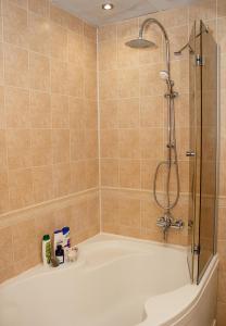 a bathroom with a shower and a bath tub at Cozy 1BD Apartment with Free Parking in the Area in Varna City