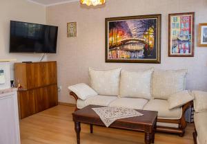 a living room with a couch and a tv at Cozy 1BD Apartment with Free Parking in the Area in Varna City