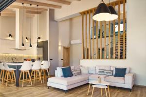 a living room with a couch and a table at Villa Belen in Kypseli +41 photos