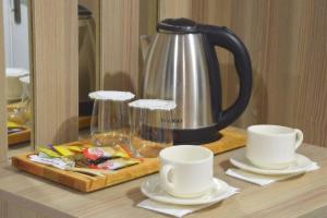 a tea kettle and two cups on a table at NAYADA OTEL SPA in Sapanca