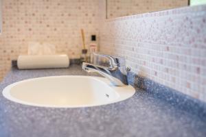 a bathroom counter with a sink and a faucet at Haus zur Vogelweide App 5 in Dobbiaco +16 photos