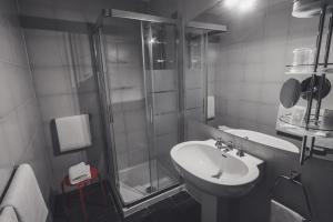 a bathroom with a sink and a shower at Hotel Britannia in Genoa