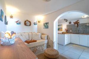 a living room with a couch and a table at Libera Apartments in Stara Baška