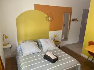 a bedroom with a bed with a large headboard at Résidence La Cigale du Désire Séjour chez l habitant in Riez