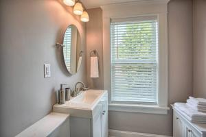 a bathroom with a sink and a mirror and a window at Suites on Seneca - Beautiful 1 Bedroom Apartment in Harrisburg +17 photos