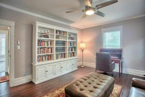 a living room with a couch and a book shelf at Suites on Seneca - Beautiful 1 Bedroom Apartment in Harrisburg