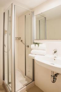 a bathroom with a shower and a sink at Minura Sur Menorca & Waterpark in Punta Prima