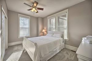 a bedroom with a white bed and a ceiling fan at Suites on Seneca - Lovely 2 Bed 1 Bath Apartment in Harrisburg