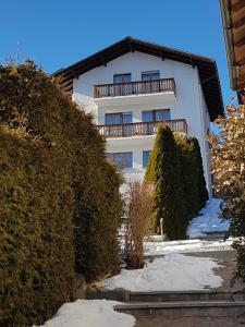 a white building with a balcony on top of it at Appartement Randogne in Crans-Montana