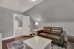 a living room with a couch and a table at Suites on Seneca - Gorgeous One Bedroom Apartment in Harrisburg