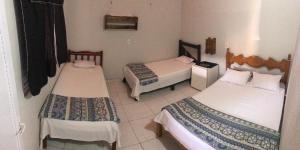 a hotel room with two beds and a room with two at Pousada Rita Brandão in Jijoca de Jericoacoara