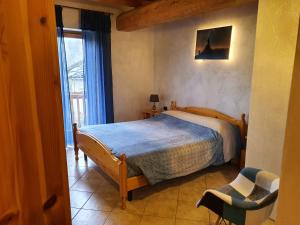 a bedroom with a bed in a room with a window at Agriturismo al pra di muriet in Susa