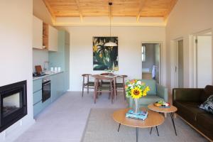 a living room with a couch and a table at Jardin de la Ferme in Franschhoek